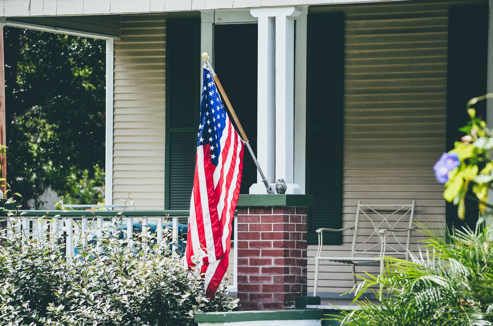 us a flag on white wooden fence